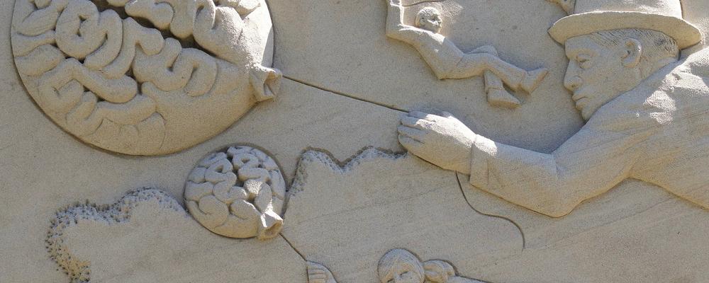 Sculpture of brain, child, man, woman